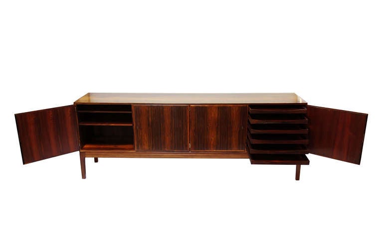 Rungstedlund mahogany credenza designed by Ole Wanscher and made by J.P. Jeppesen.
Two double doors, back of rosewood veneer, rosewood interior: Shelves, drawers and trays.

Brass hardware.

Rungstedlund series.
