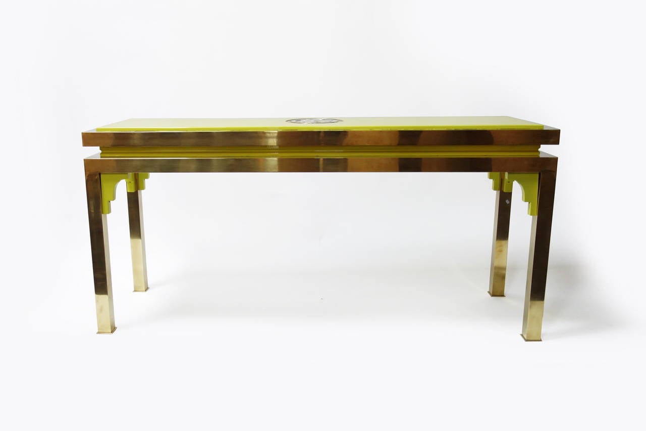 Elegant lacquered wood and polished brass console table by Tommaso Barbi.

Brass structure with lacquered wood details.
Brass plate insert in the tabletop, inspired by Japanese mon, could be interpreted as stylized flower petals,

Italy, circa
