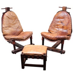 Set of two brazilian leather chairs with one footrests.