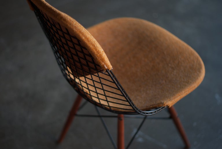 Rare swivel dowel leg chair with walnut legs, designed by Charles & Ray Eames for Herman Miller, swivel mechanism from Seng of Chicago, wire top with original honey yellow bikini, original label to underside of cover.