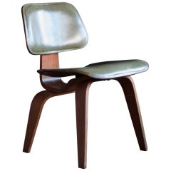 Important early Charles & Ray Eames DCW with green leather seat and back.