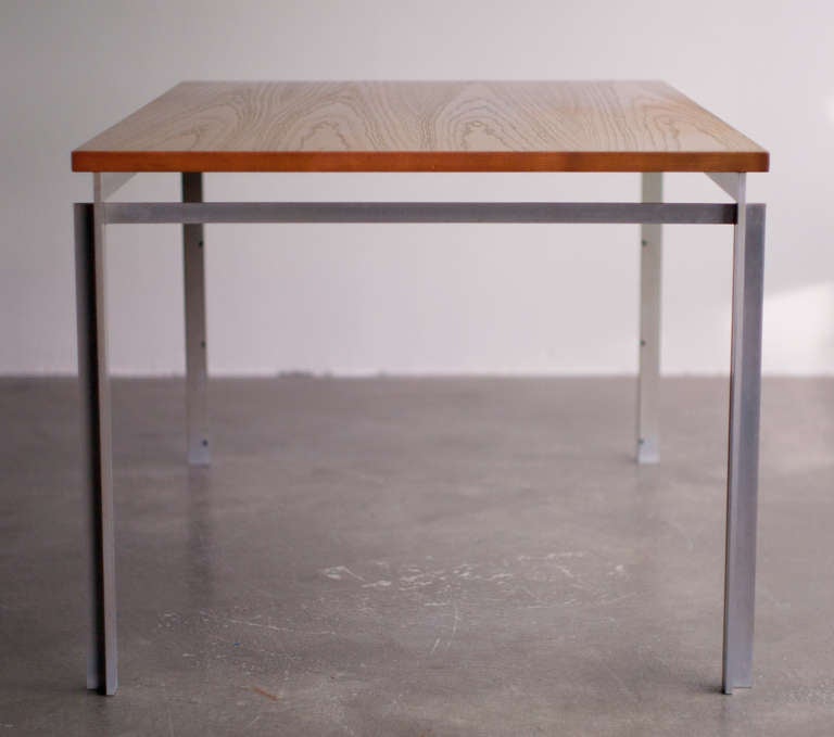 Danish design from 1957 by Poul Kjærholm for E. Kold Christensen. 
Matte chromed flattened steel frame,  oregon pine table-top. 
Frame marked with embossed stamp. 
We offer museum quality crating and affordable worldwide shipping. Feel free to