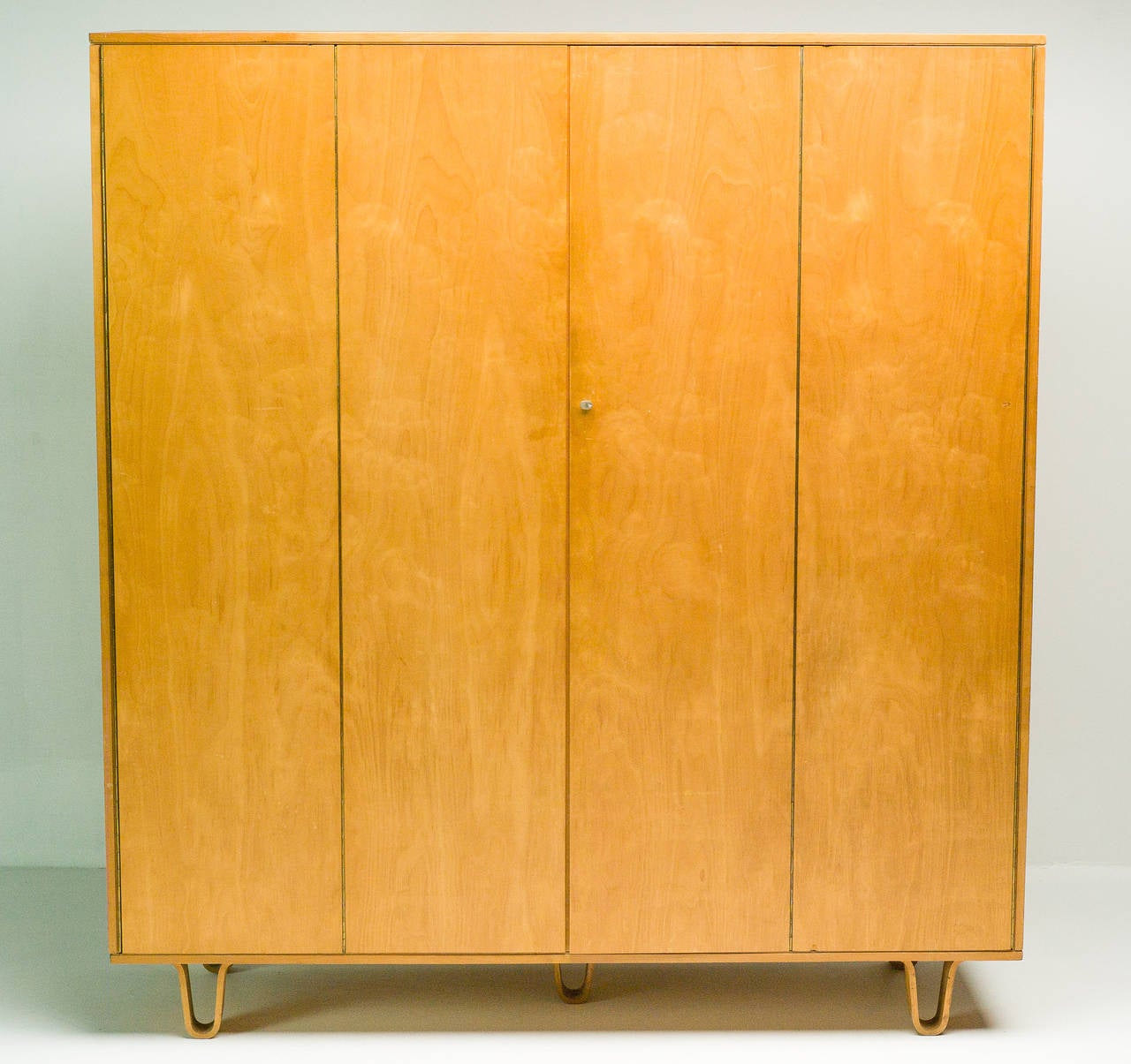 Large Pastoe wardrobe KB04 with the trademark bent plywood legs designed by Cees Braakman for Pastoe. From the first owner with all original interior.
Shelves, bent plywood drawer, bent plywood shelf, mirror and hanging rod. 
Please check out the