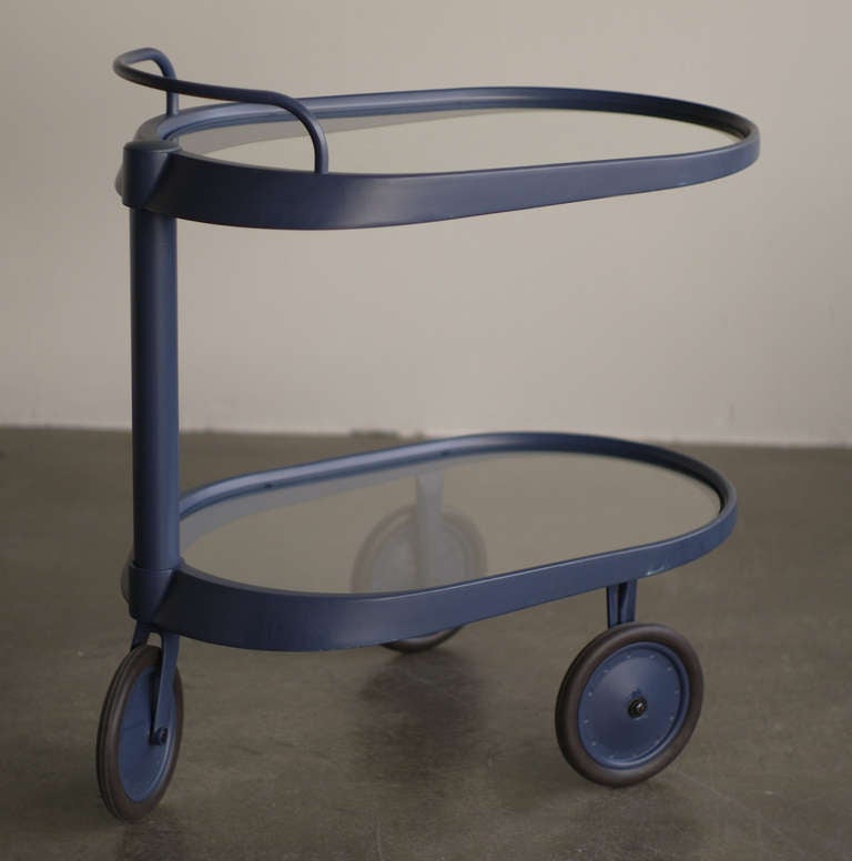 Modern trolley designed by Enzo Mari for Alessi in 1989.
Handlebar above a cylindrical shaft side support, on three wheels, stamped Alessi.
In a blue/grey color; very elegant.
We offer museum quality crating and affordable worldwide shipping.