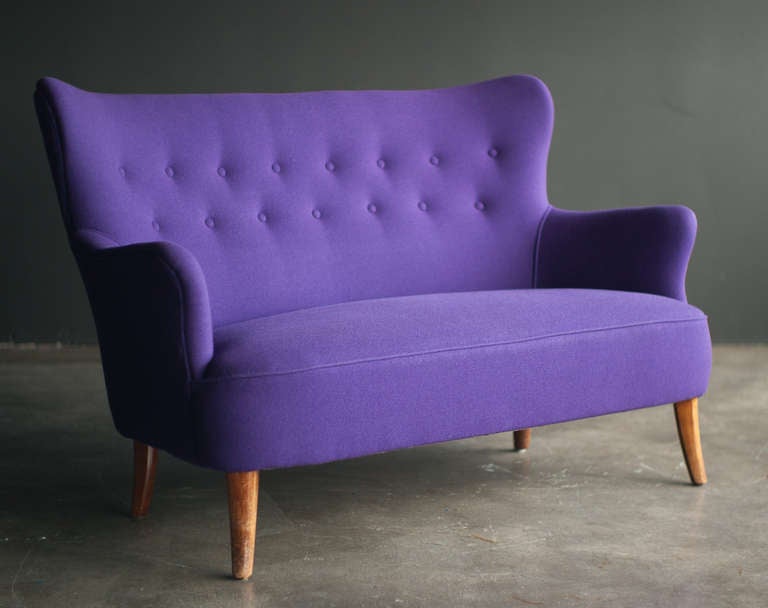 Mid Century Modern lounge chair designed by Theo Ruth for Artifort. Teak legs and reupholstered with beautiful purple Kvadrat Tonus wool fabric. Complete with matching teak coffee table by Spectrum, The Netherlands. 
The fabric is flawless, the
