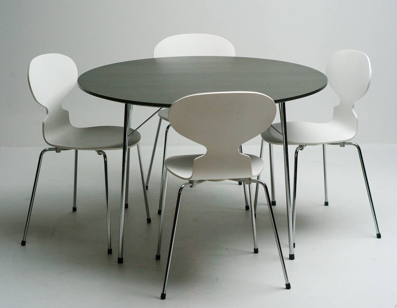 Table with dark grey lacquered top on polished chrome steel legs and stretchers. Stacking 