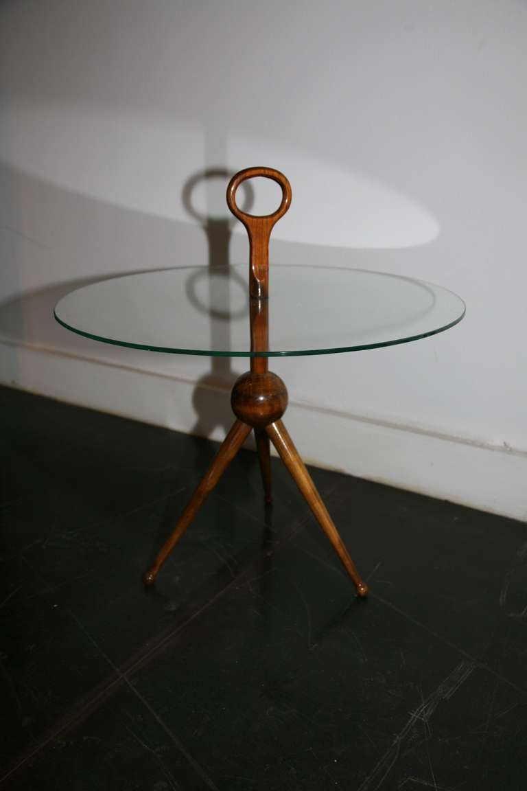 Circular wooden guéridon, suspending glasstop.