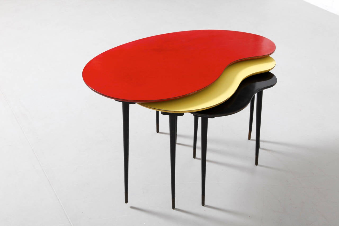 In the style of Willy Van Der Meeren kidney-shaped side tables in wood, lacquered in yellow, red, black, typical for the Expo 1958 in Belgium, with wooden legs.
You can make a round coffee table of it or use separately as a side table.
Original