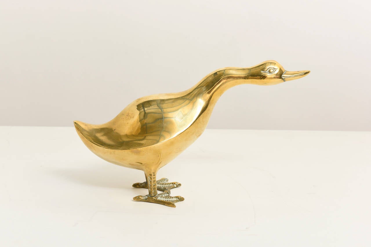 Charming sculpture of a brass duck figure. 
This large sculpture by Sarreid has a generous presence. It looks great on a console on your coffee table or sideboard.