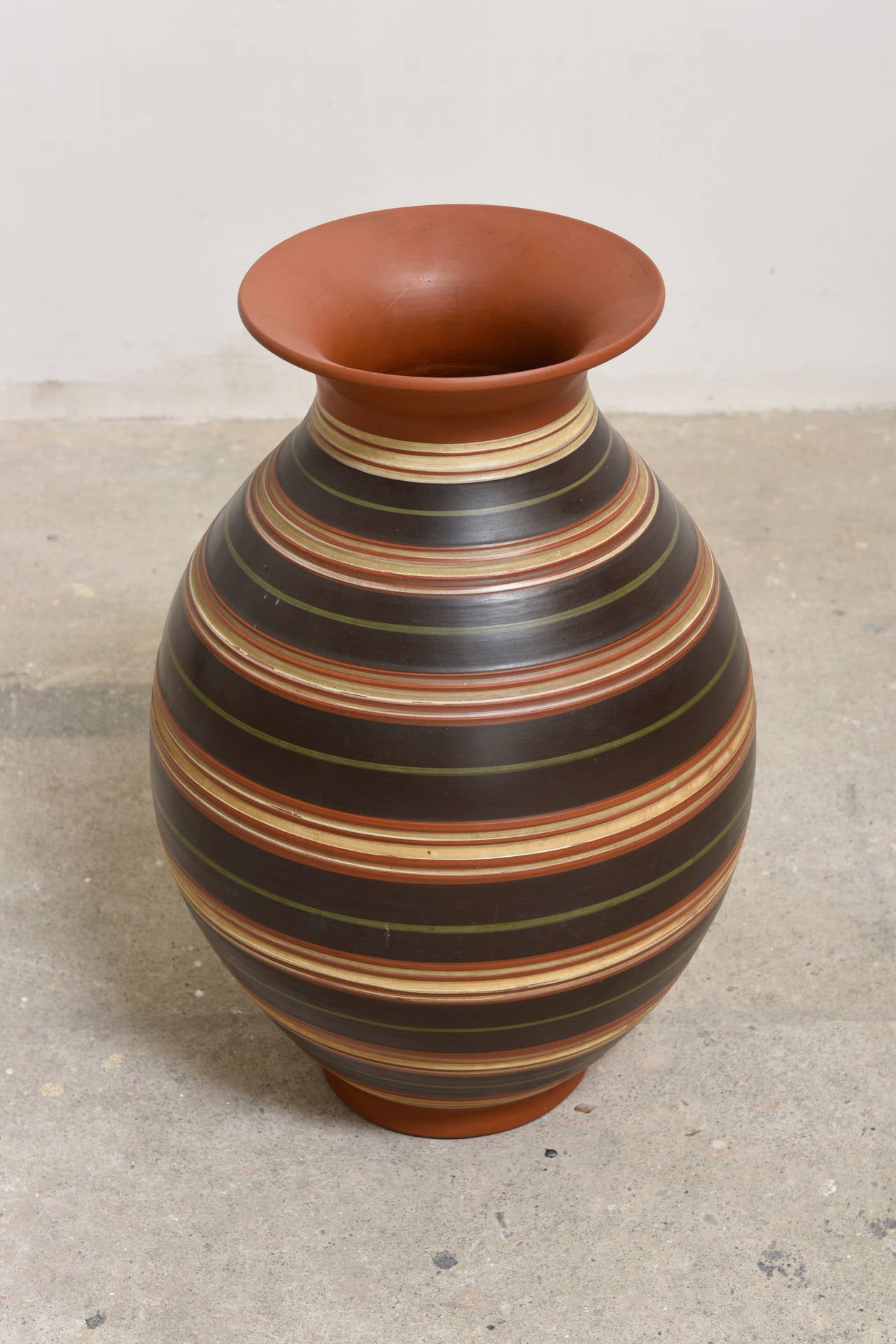 A gorgeous vase made of red clay by Ilkra Edelkeramik, 
Ransbach-Baumbach, West Germany. Labeled.

A beautiful handmade vase with carved horizontal rings, green, brown and white. 

The condition is excellent.