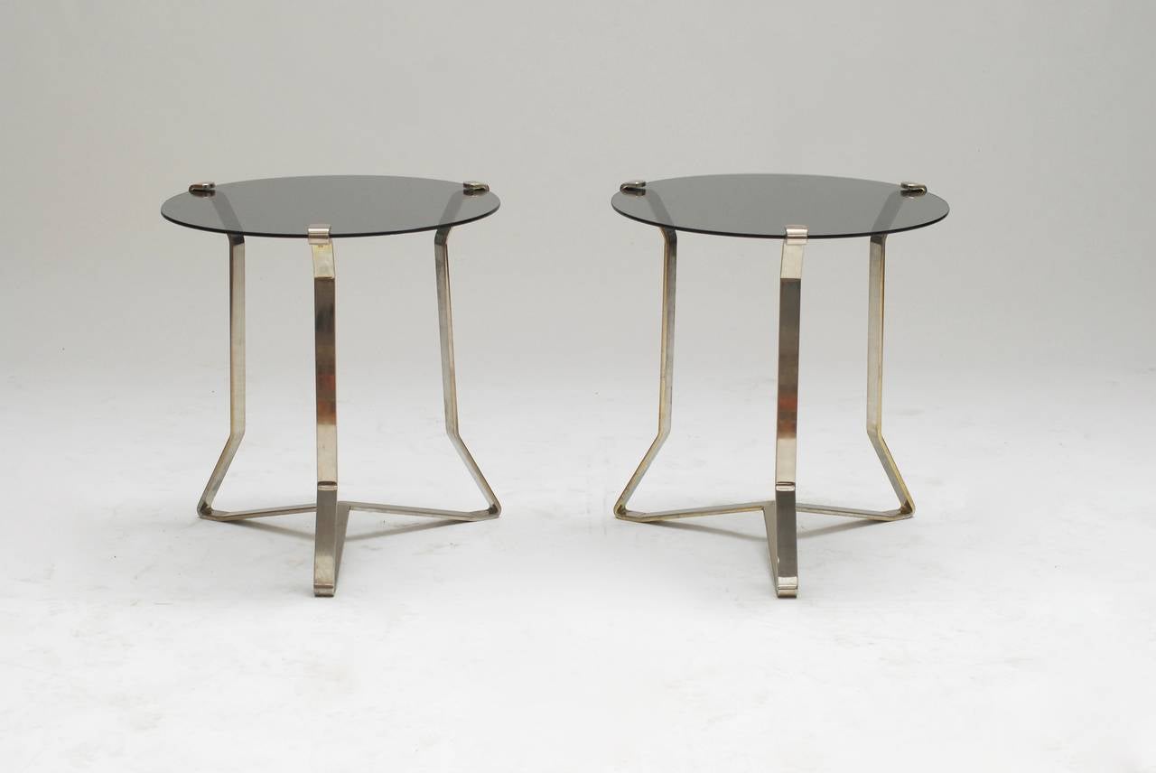 Great pair of side tables in heavy thick steel. Very interesting design that makes me think of François Arnal and Atelier A or Jacques Adnet. It was acquired in the 1960's in France by the previous owners. The glass and metal is being held on place