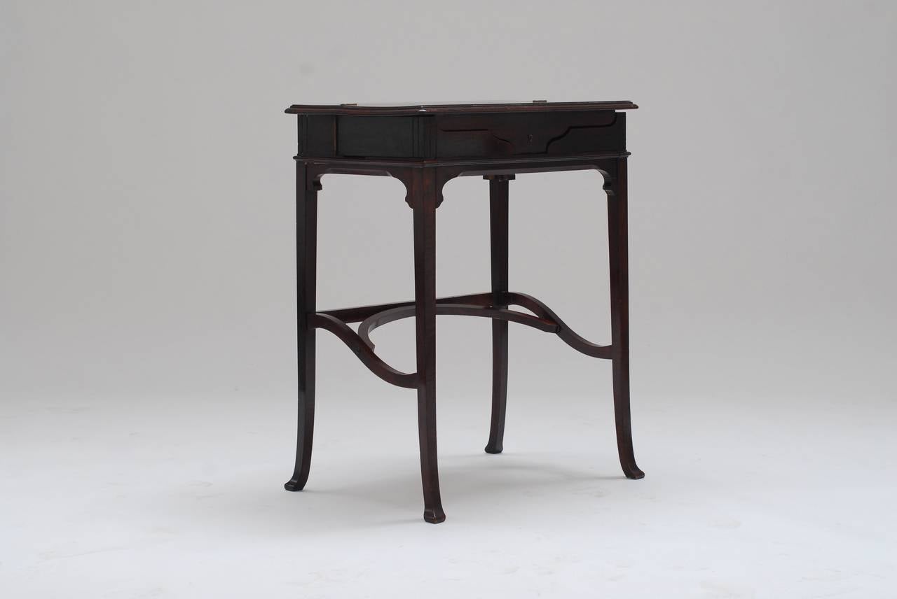 Very elegant and practical writing desk. When the top part is lifted the side parts swivel out automatically. A very precise and ingenious system. The desk is signed and dated with initials and a serial patent number.