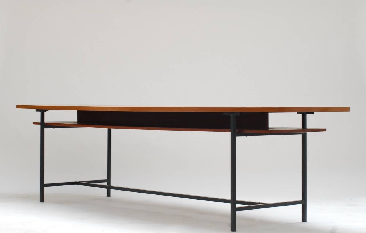 Unusual teak table made by the Jasisnski atelier mid 1950's. It's a slim and elegant model with a sub niveau to put paperwork or other utensils. 
The model is designed as a conference table but can be used as a dining table too of course. The top