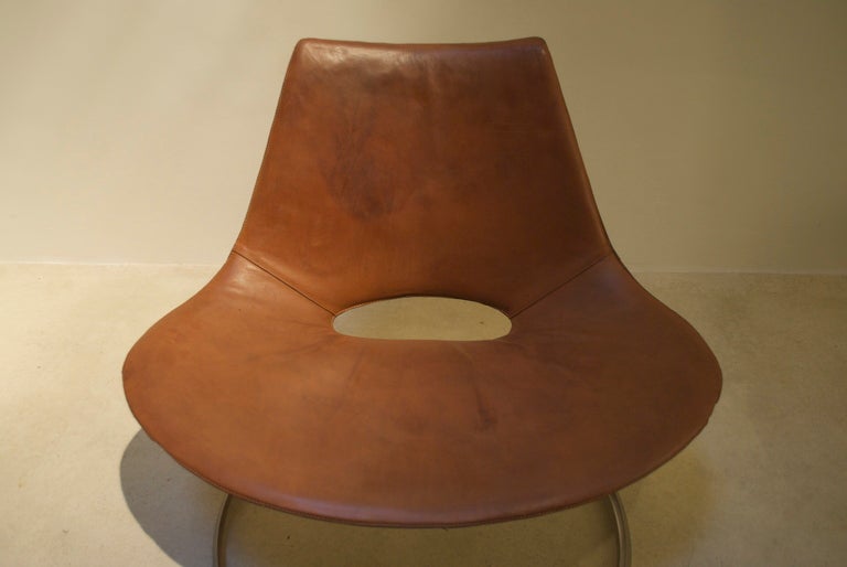 Great cognac leather easy chair by Kastholm & Fabricius. It's the original natural leather cover with great patina. 
The chair is marked with the Ivan Schlechter monogram in the steel frame and leather.
This iconic chair was way ahead it's time and