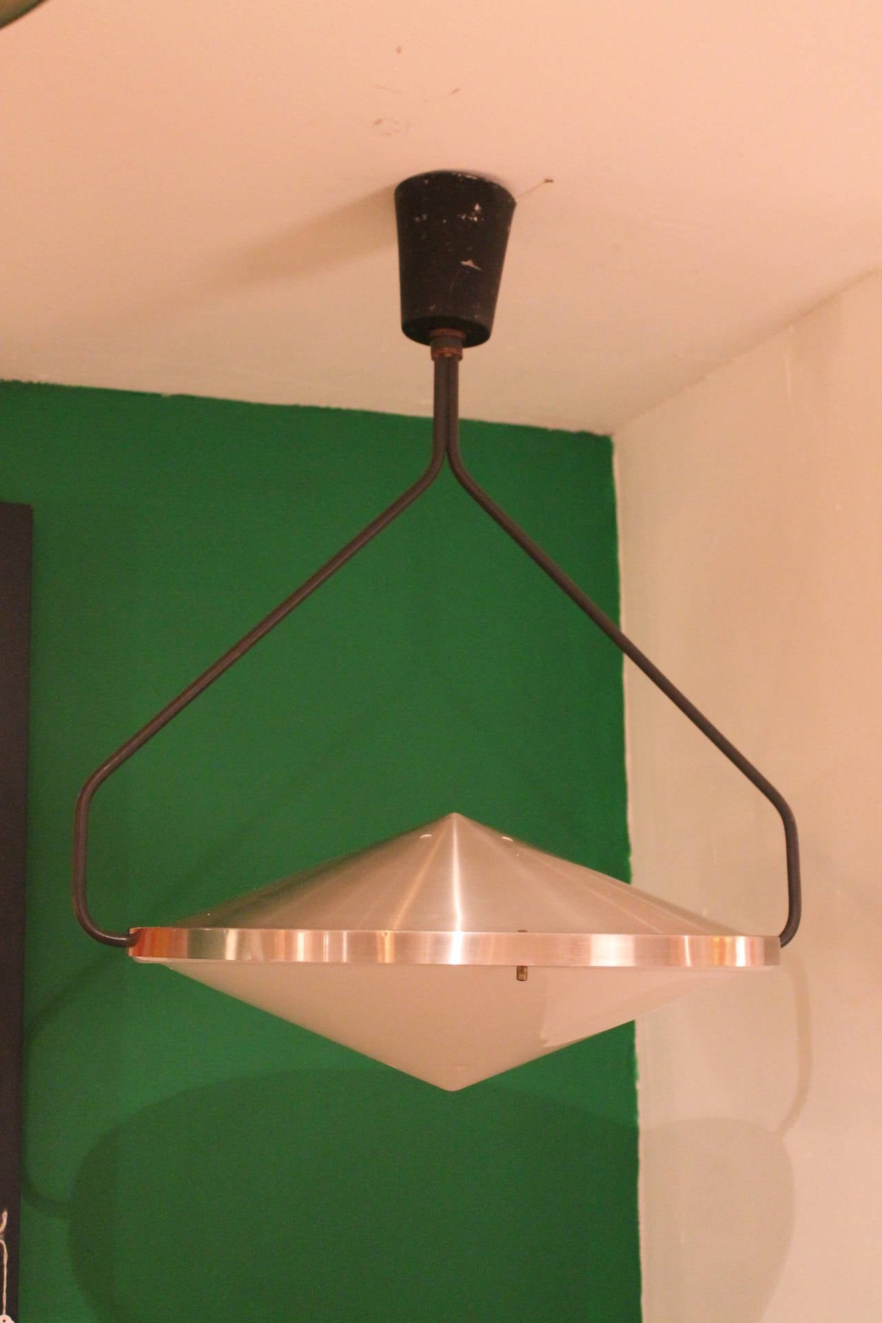 RAAK pendant by B. Lodder for RAAK in 1972.

This lamp is gimbaled to hung like a compass on a ship and can be rotated 180 degrees, metal and plexiglass with pull-pendant.