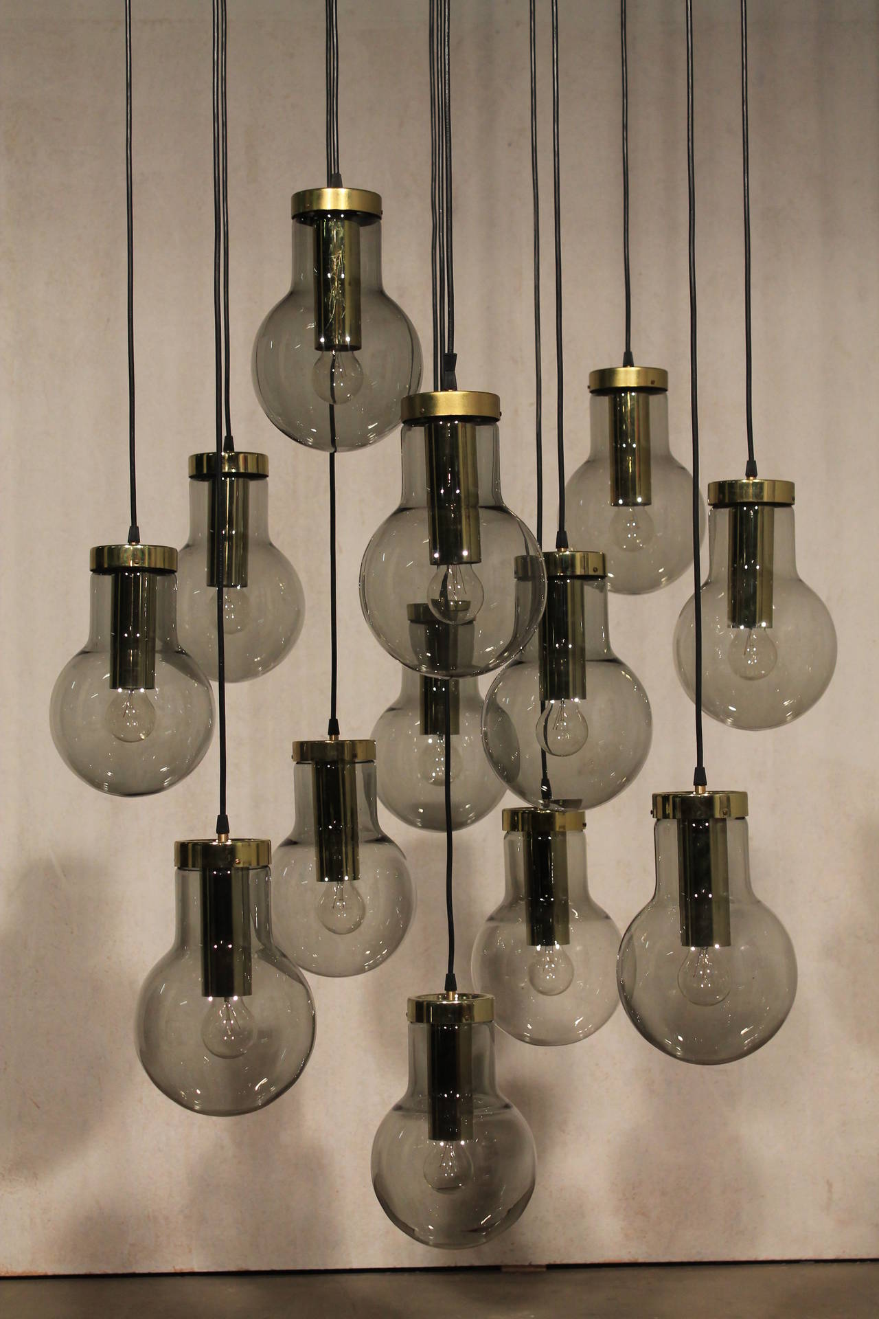 Impressive large maxi bulb chandelier, Holland, 1960s. 

13 maxi bulb smoked glasses with brass hardware.

Rewired also for US, adjustable in height.

Diameter ceiling plate 80 cm or 31.5