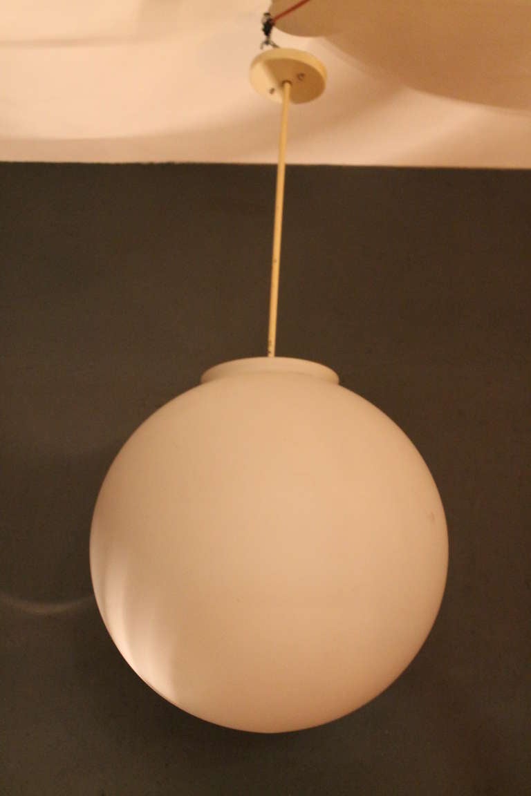 7 XXL white opaline glass globe lamps by RAAK, Holland, 1960.

Hanging on metal stem.