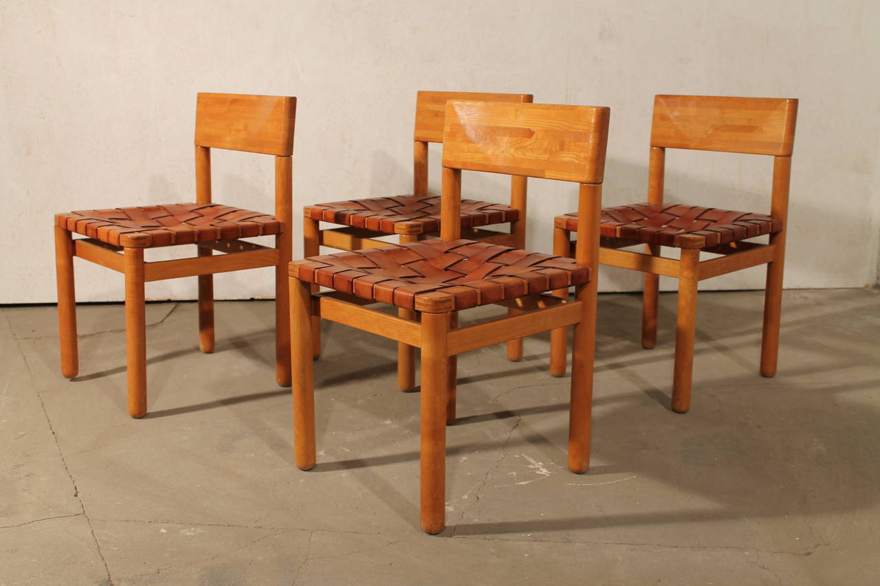 Four dining chairs in pine wood with leather seat, Scandinavian, 1960s. 

Very nice details in the wood, also very nice patina on the leather belts. 

Good and strong condition. 

We ship worldwide contact us for info. 
We can send high