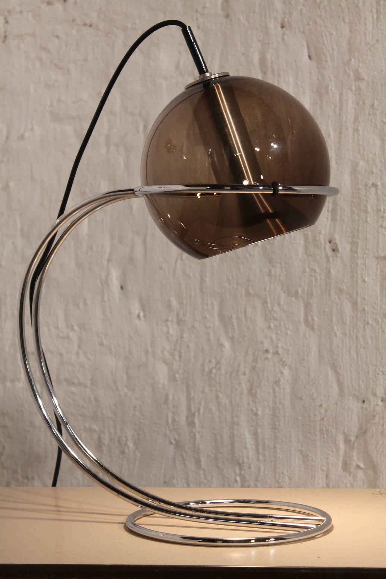 A glass globe desk lamp

Smoked glass with aluminium hardware and a chrome metal base.

Rewired also for US use.