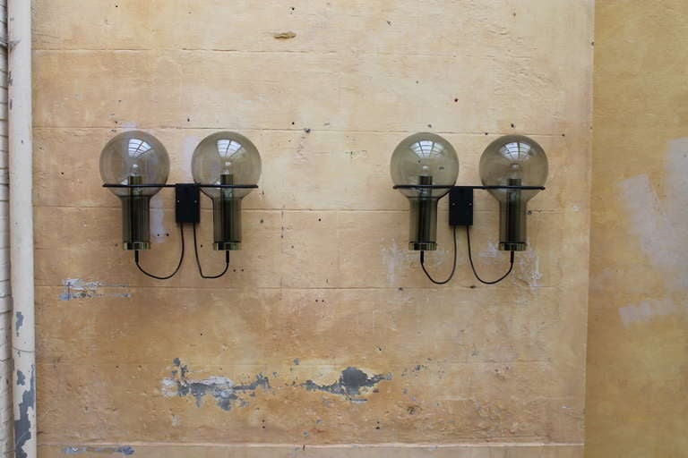 A pair 2 maxi globe wall sconces by RAAK Amsterdam 1960's

a matching pair  smoked glass maxi bulbs with brass hardware

in very good original condition 

we also have a big custom made chandelier from the  same building 
there is also a 3rd