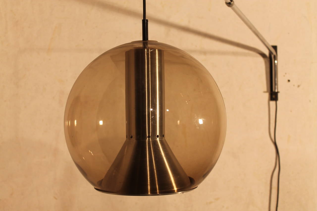 Big wall lamp by RAAK.

Smoked glass ball with metal details. 

Wired also for US use.
