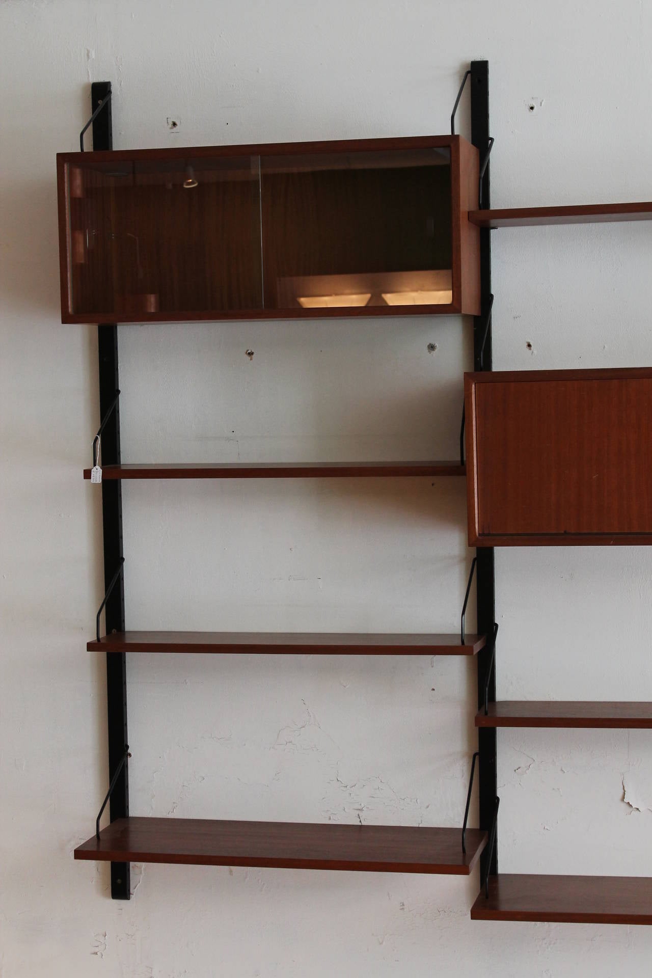Teak wall unit, Denmark, 1950, Poul Cadovius. 

Good original condition with normal users wear. 

Key from cabinet is missing.

We will ship worldwide please contact us for info.
We can send high quality pictures please contact us.
