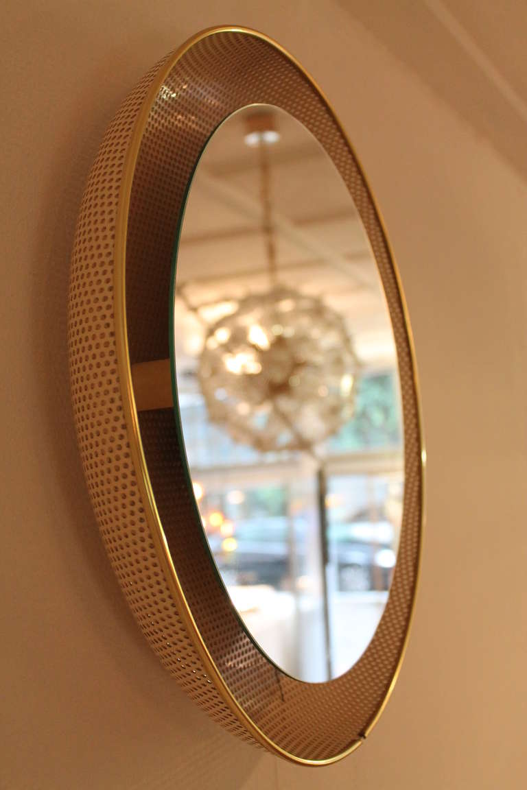 Lighted mirror by Artimeta Holland 1960 s

white perforated metal with gold details  

3 light bulbs  , also wired for US use 

good condition