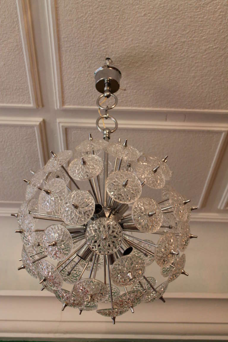 Belgium snowflake sputnik chandelier chrome and cristal glass 1960s

complete and no damage to glasses 
wired also for US use ,  some very little wear to the chrome

12 light bulbs