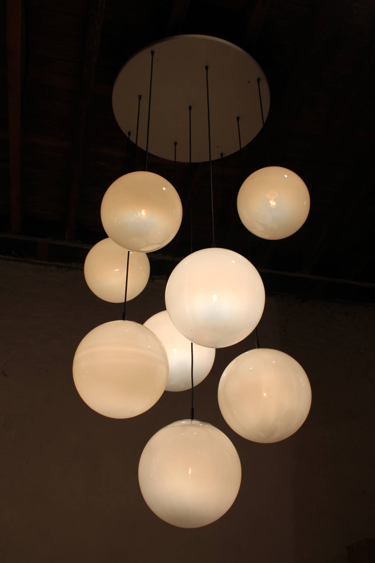 Two large white foggy glass ball chandeliers, 1960s. 

Two  extra-large glass balls chandeliers. 

Costume made in 1960s for a School Antwerp Belgium.
Each chandelier has nine handmade glass balls, hanging on original metal ceiling plate. High
