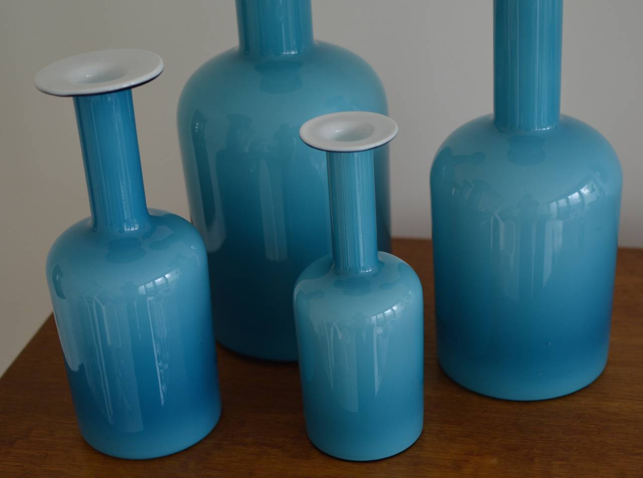 Set of four iconic turquoise blue cased glass 'Gulvvase' vases by glassblower Otto Brauer, based on a 1958 design by Per Lutken for Holmegaard. 

Rarely seen in a set of four pieces in these large sizings, as followed:
H: 44 x 17 cm. 
H: 37 x