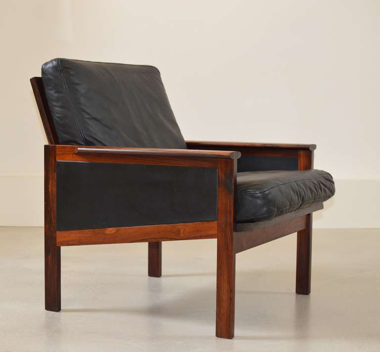 Arm chair model 4 from the Capella Series designed in 1958 by Illum Wikkelsø executed in beautiful Rosewood with black leather loose cushions.  

A matching three seater sofa also available. 
Please enquire.