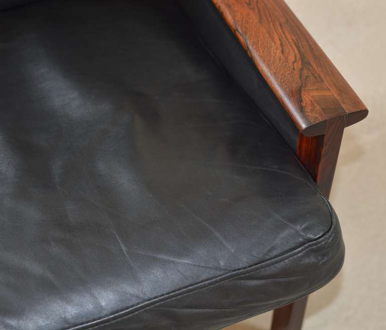 Scandinavian Modern Rosewood and black leather Capella Series arm chair by Illum Wikkelsø