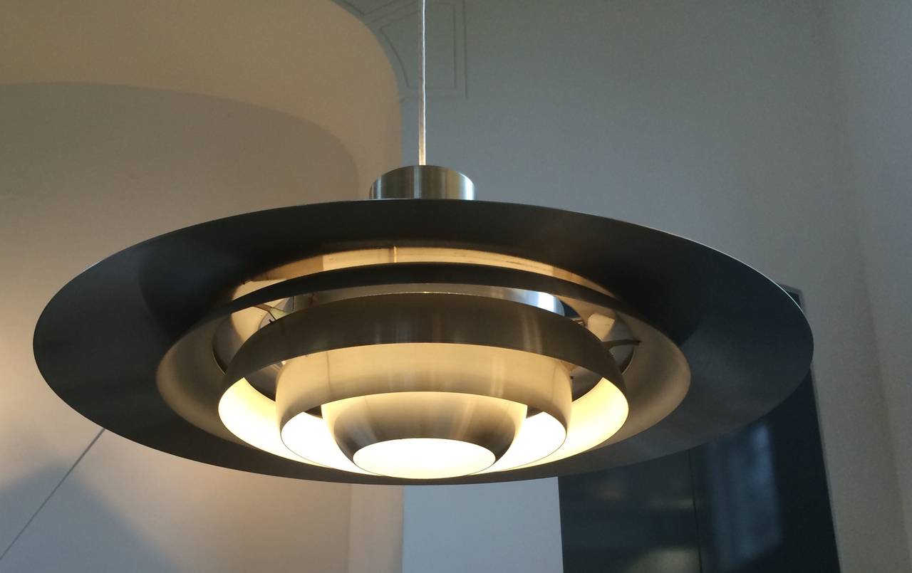 Impressing and rarely seen largest size ( Ø 70 cm ) pendant designed in 1963 by Preben Fabricius and Jørgen Kastholm for Danish nordisk solar executed in brushed aluminum. 
A striking and strong design pendant that provides a wonderful glare-free