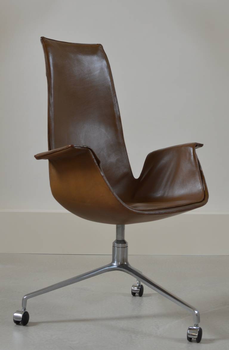 Beautiful original brown leather swiveling high-back desk chair by Preben Fabricius & Jorgen Kastholm on signature tripod cast aluminium base with castors. 
Signed to underside 'Alfred Kill'.