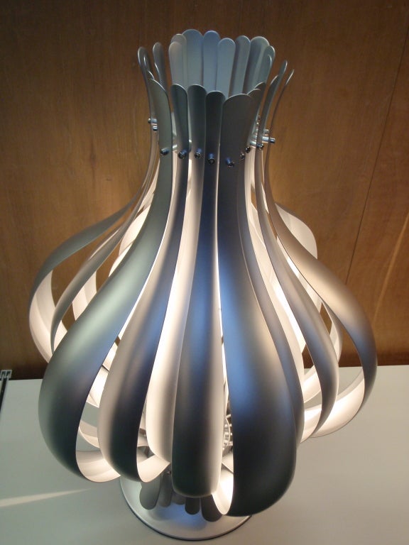 Extraordinary lighting object consisting of compressed lamellae of silver finished steel straps producing an onion shape. 
A wonderful object that brings a fantastic indirect light into the room. Designed in 1977. 
Comes with a cord with switch,