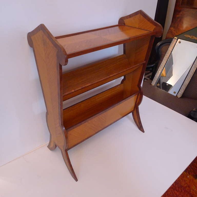 a fine magazine rack furniture in limon wood and walnut.