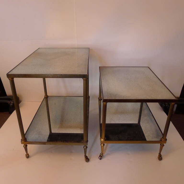 a set of two bar cart in bronze with patined mirror shelves.