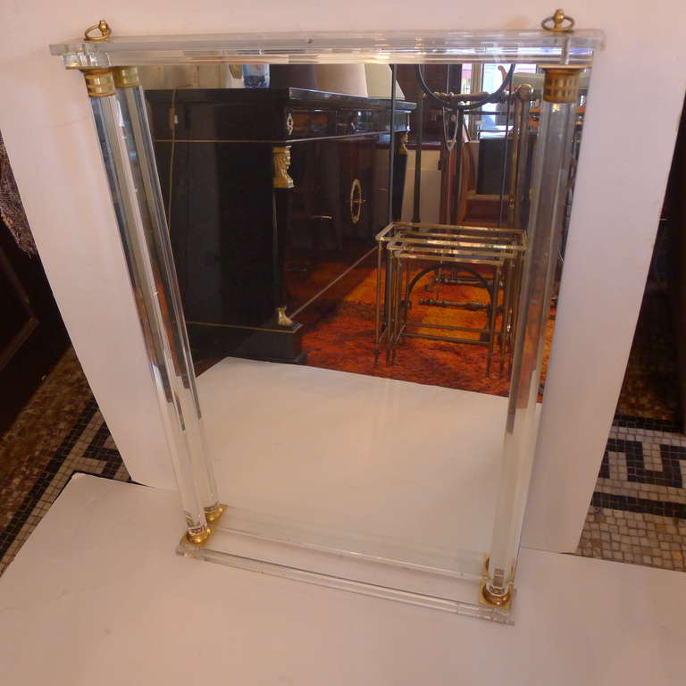 a fine trumeau mirror in plexiglas with bronze details