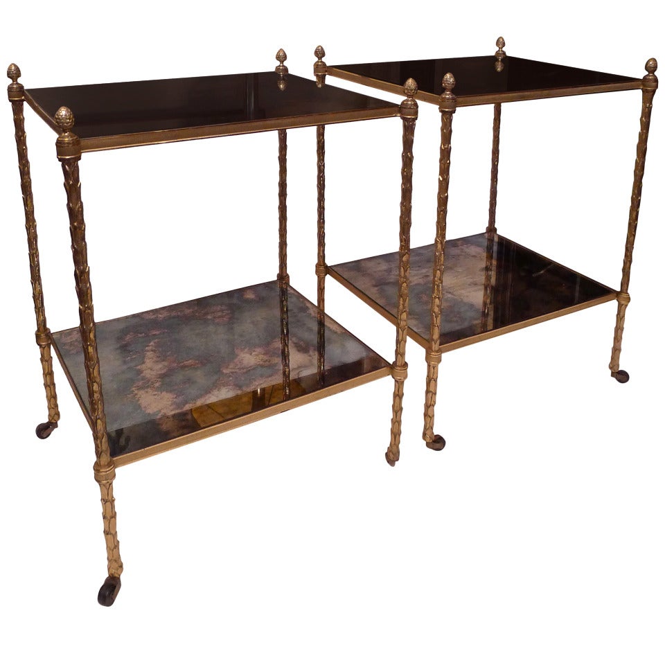 a pair of two tier Bagues side tables in bronze