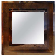a large square mirror circa 1970
