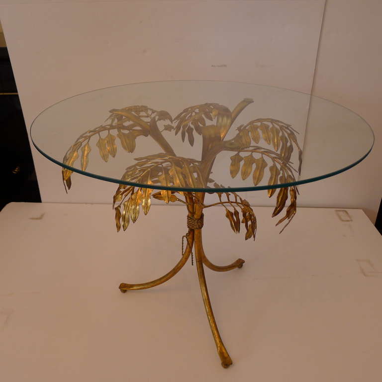 a fine gilded iron coffee table with leaves form.