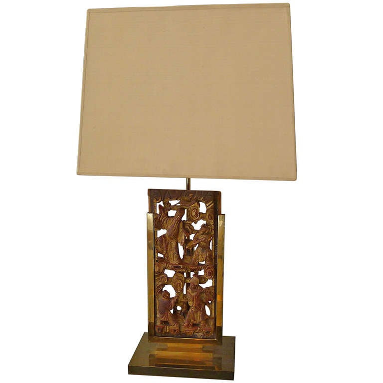 a tablelamp in bronze with a chinese decorative panel.