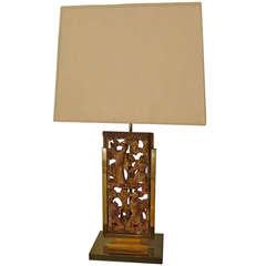 a tablelamp in bronze with a chinese decorative panel.