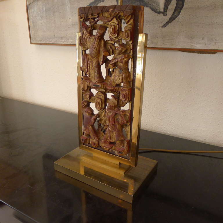 Modern a tablelamp in bronze with a chinese decorative panel.