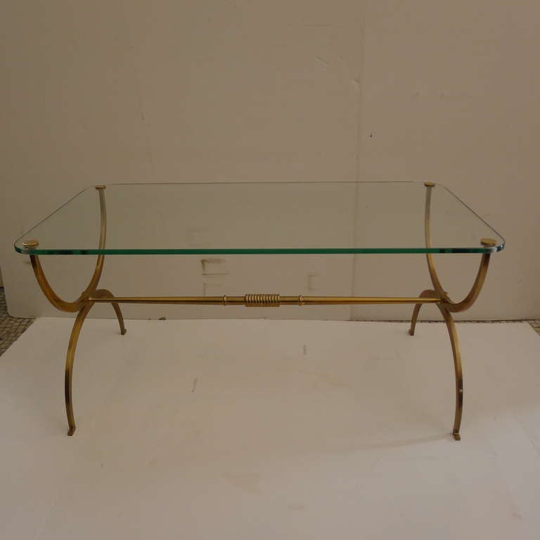 A fine coffee table in bronze with glass tabletop