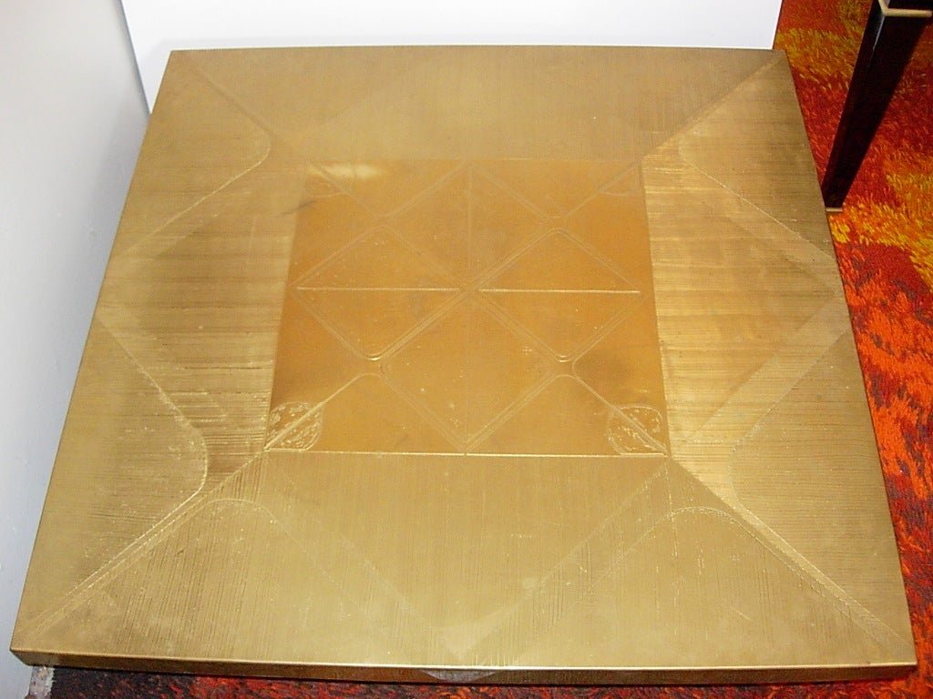 A signed Armand Jonckers square bronze coffee table with hand
etched abstract design top with a bronze base.