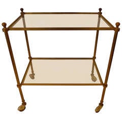 a two tier bar cart in bronze attributed to Jansen