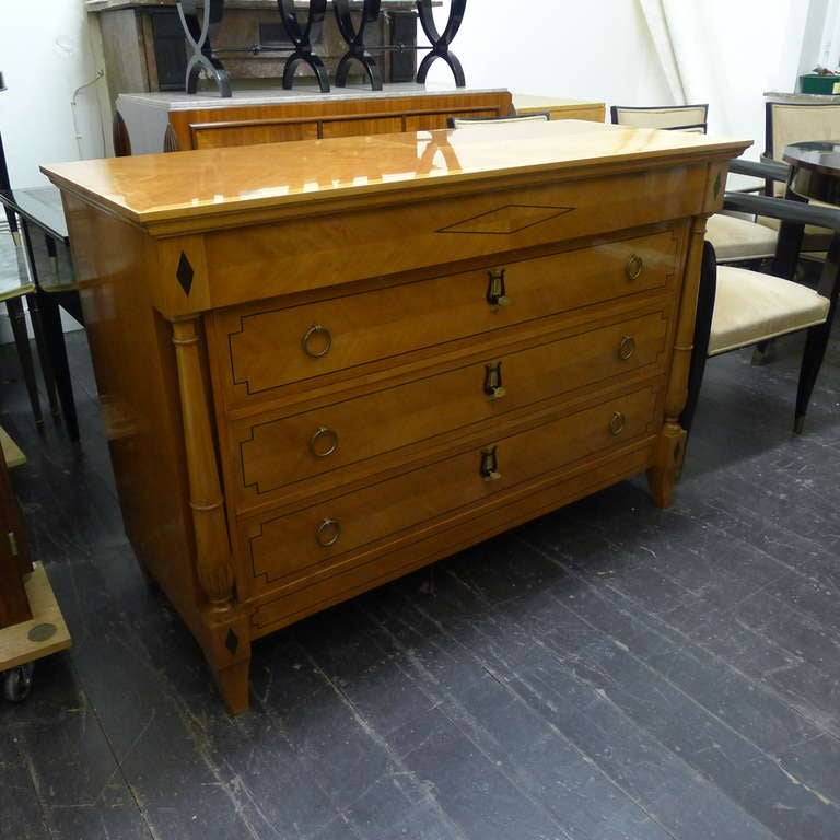 a neo-classical chest of drawers in fruitwood with bonze details.