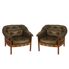 A set of two Arne Norell chairs in green leather