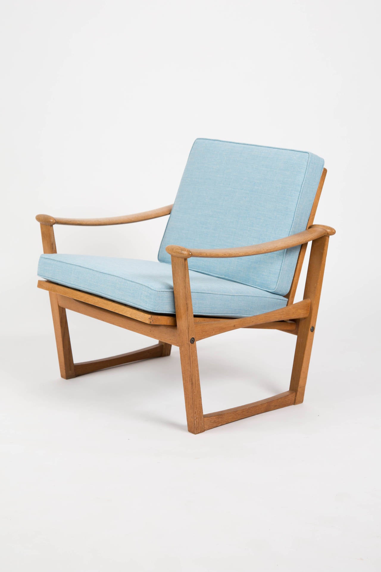 Finn Juhl style. A set of two Finn Juhl style lounge chairs made by Pastoe. The chairs are designed by M.Nissen in Demark. The chairs are of oak wood. The chairs are reupholstered with a blue fabric of wool and hemp. Long time people thought the